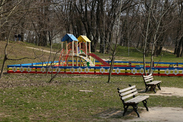 Obraz na płótnie Canvas playground, grass and benches in the park