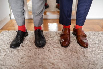 Two men in shoes and red socks
