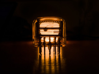 Old neon radio lamp is glowing  in the dark