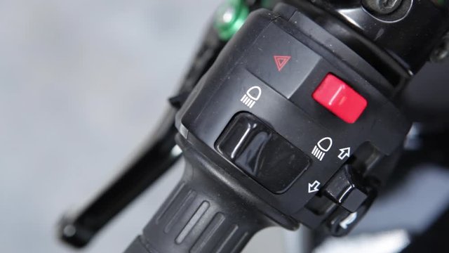 Macro detail of light and horn switches in a naked motorcycle