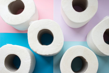 Toilet paper rolls on minimalistic style background. Overhead flat lay format. Hoarding concept for Coronavirus fear. Scarce goods, contactless delivery