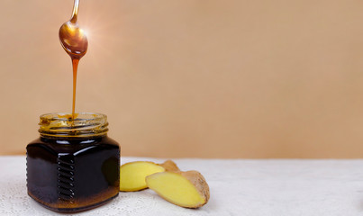 Buckwheat honey pours from spoon into jar