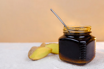 Buckwheat honey sliced ginger and spoon