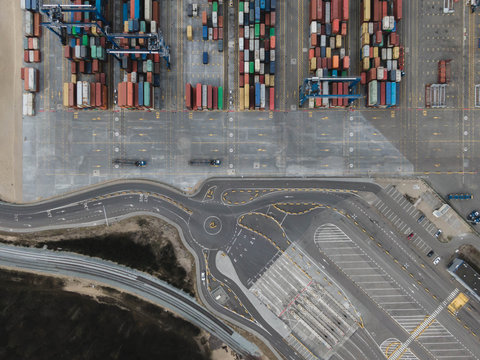 Aerial drone photo of colorful transport 20 and 40 feet containers stacked in container terminal.  Top down view.