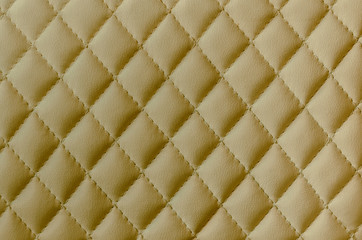 Leather texture background. Yellow leather stitched with threads