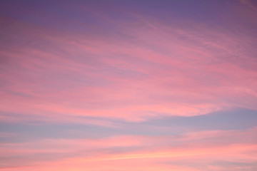 Blue sky at sunset with bright stains of orange and pink. Concept landscape, abstraction.