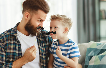 Father's day. Happy funny family son and dad with mustache .