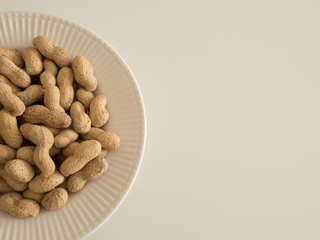 white bowl of peanuts
