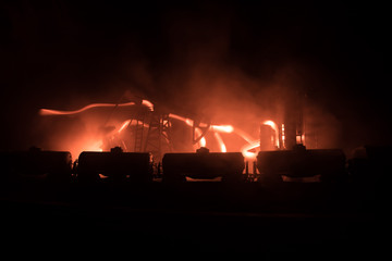 Train moving in fog. Ancient steam locomotive in night. Night train moving on railroad. orange fire background. Horror mystical scene