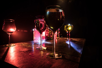 Goblet of white wine on wooden table on wooden wall background