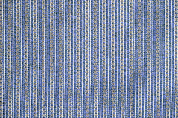 The texture of lined blue coarse cloth, the background of the carpet with the lines of the seams