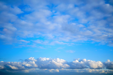 Altocumulus and cumulus clouds on the sky, background, copy space for text