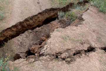 landslide in an environmentally hazardous area large crack in ground descent of large layers of...
