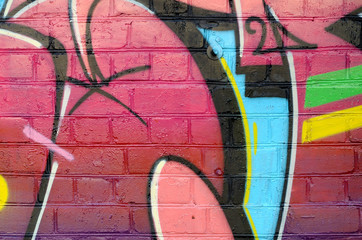 Abstract colorful fragment of graffiti paintings on old brick wall. Street art composition with...