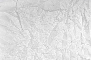 White wrinkled creased paper texture. Blank crumpled grainy paper textured surface. Smudged grungy grey poster. Close up. Material tissue for packing.