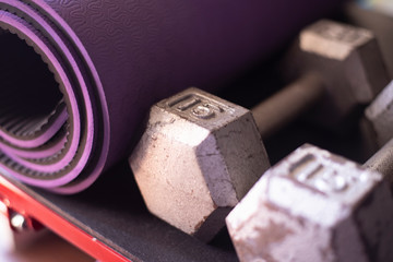 Dumbbells and yoga mat on a  step platform