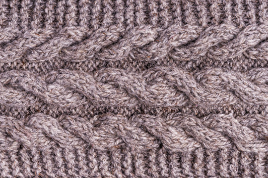 Wool grey knitted texture. Woolen gray cloth, handmade. Textile ornament. Fashion knitwear. Light wool yarn. Fabric texture. Winter scarf. Seamless pattern. Closeup