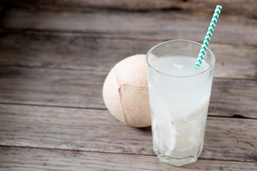 Fresh coconut juice in a glass with coconut white meat isolated on white