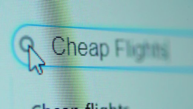 Computer monitor with Cheap Flight Tickets text on browser tab. Search Engine Concept. Shot in 4k resolution