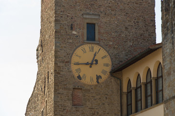 Fototapeta na wymiar Close up view of clock tower of the Communal Palace or Palazzo Dei Priori in Arezzo, Tuscany, Italy.