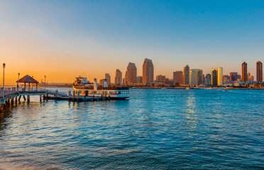 San Diego Bay at dusk with ferry at dock.