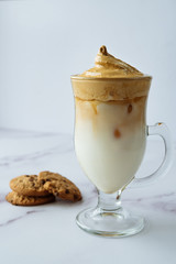 Dalgona coffee, a modern smooth, creamy and fluffy coffee with milk and ice. Korean drink is trending