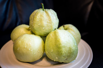 Guava is a fruit of Thailand. On a white plate.
