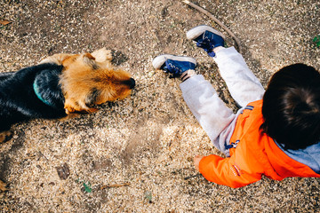 Kid and his dog playing outside