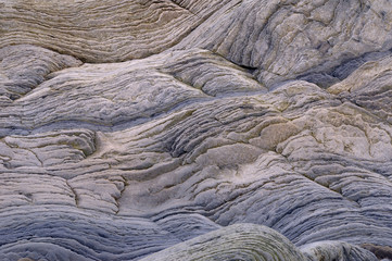 Abstract pattern of wavy sedimentary layers of stone at the Bay of Fundy Cape Enrage