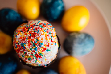 Fototapeta na wymiar colored eggs and Easter cake on a plate