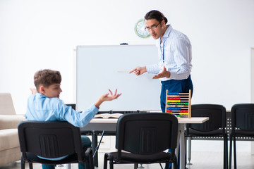 Young father helping his son to prepare for exam