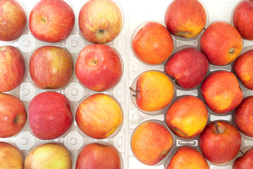 Fresh red apples close up on white background, view from above.