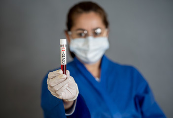 Scientist testing coronavirus positive blood sample researching for COVID-19 vaccine