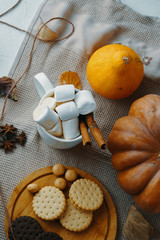 Pumpkin With Cups Of Coffee. Cup of coffee and pumpkin with marshmallows. On white wooden table