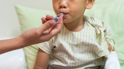 boy patient take medicine on syringe