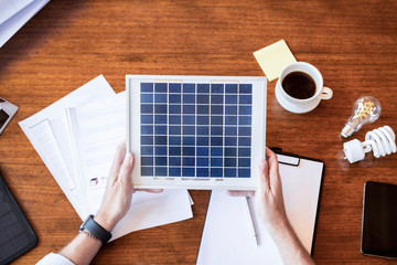 Man holding a solar panel sample