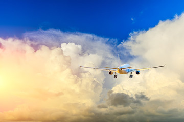 Commercial airplane flying in beautiful sky at sunset,travel concept.
