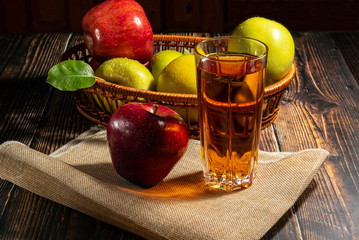 Glass of apple juice on the table. A delicious refreshing on hot days