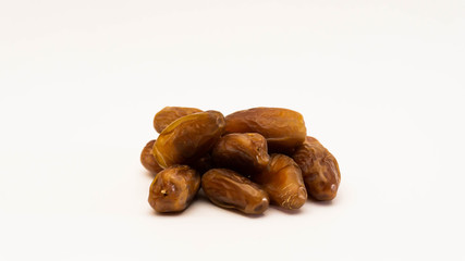 A pile of dates or kurma on isolated white background.