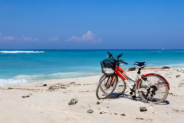 Fototapeta na wymiar Bicycles on a white sand beach
