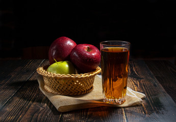 Glass of apple juice on the table. A delicious refreshing on hot days