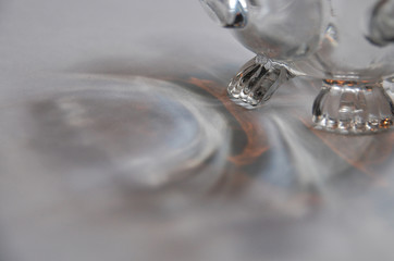 Glass sugar bowl with light shining through, illuminating peach, white, and blue light in a beautiful airy pattern of reflection.