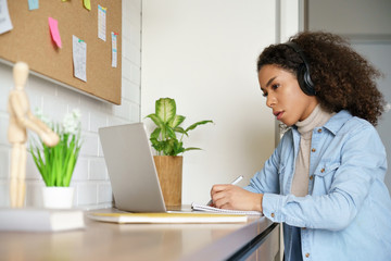 African teen girl college student, school pupil, remote worker learning with online tutor studying...