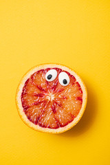 funny blood orange on the yellow background