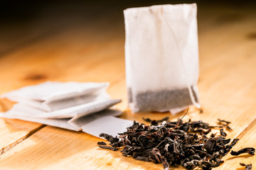 Tea bag on wooden background.