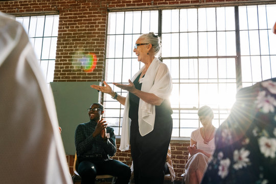Senior businesswoman talking to a crowd