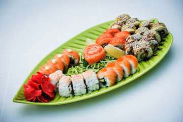 Large sushi set on the green plate.