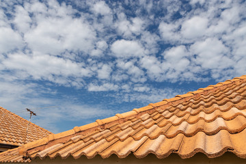 Close up of brown clay roof tiles. Red old dirty roof. Old roof tiles. Construction equipment build a house.