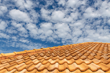 Close up of brown clay roof tiles. Red old dirty roof. Old roof tiles. Construction equipment build a house.