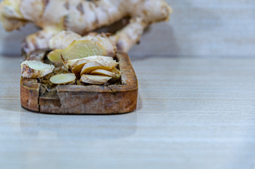 Ginger root (Zingiber officinale) on light and woody background